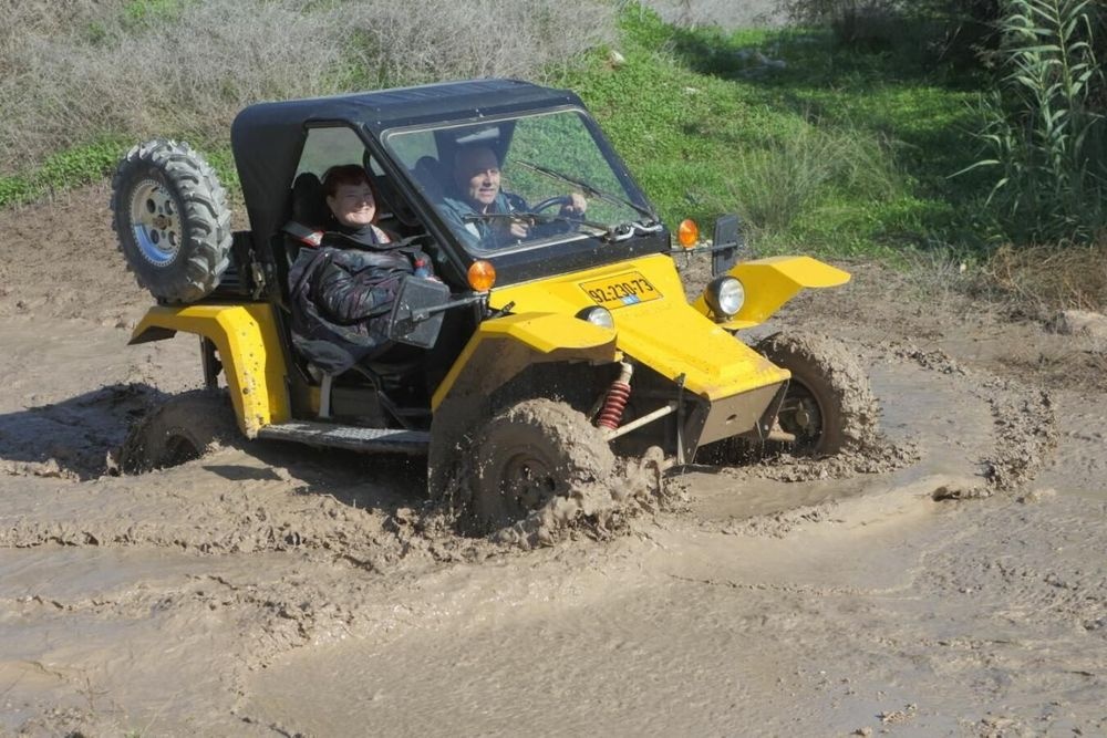 Matzok yellow buggy splashing through mud on off road trail
